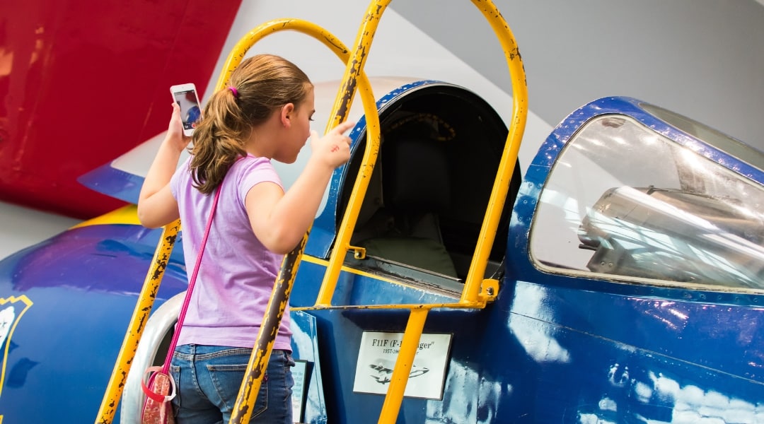 Child exploring a Blue Angels plane at the Naval Aviation Museum Pensacola Florida