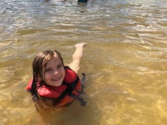 Young child swimming at White Sands Day Lake Beach