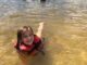 Young child swimming at White Sands Day Lake Beach