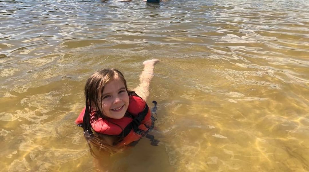 Young child swimming at White Sands Day Lake Beach
