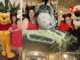 A collage of photos from the Crystal Palace restaurant at Magic Kingdom. Two women pose with Winnie the Pooh, Eeyore, and Tigger. Includes a shot of the "Crystal Palace" sign and the Victorian-style glass architecture at night.