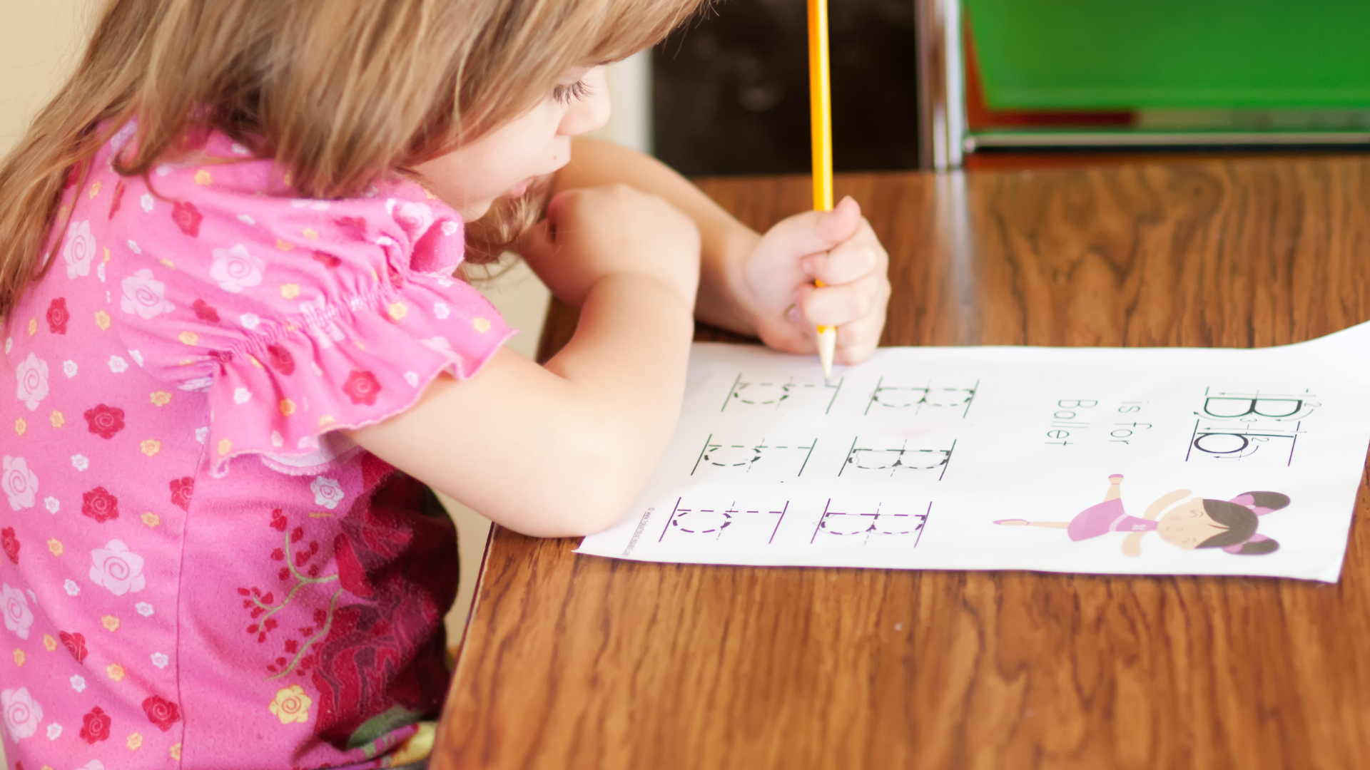 Preschooler tracing the letter B for Ballet during homeschooling 