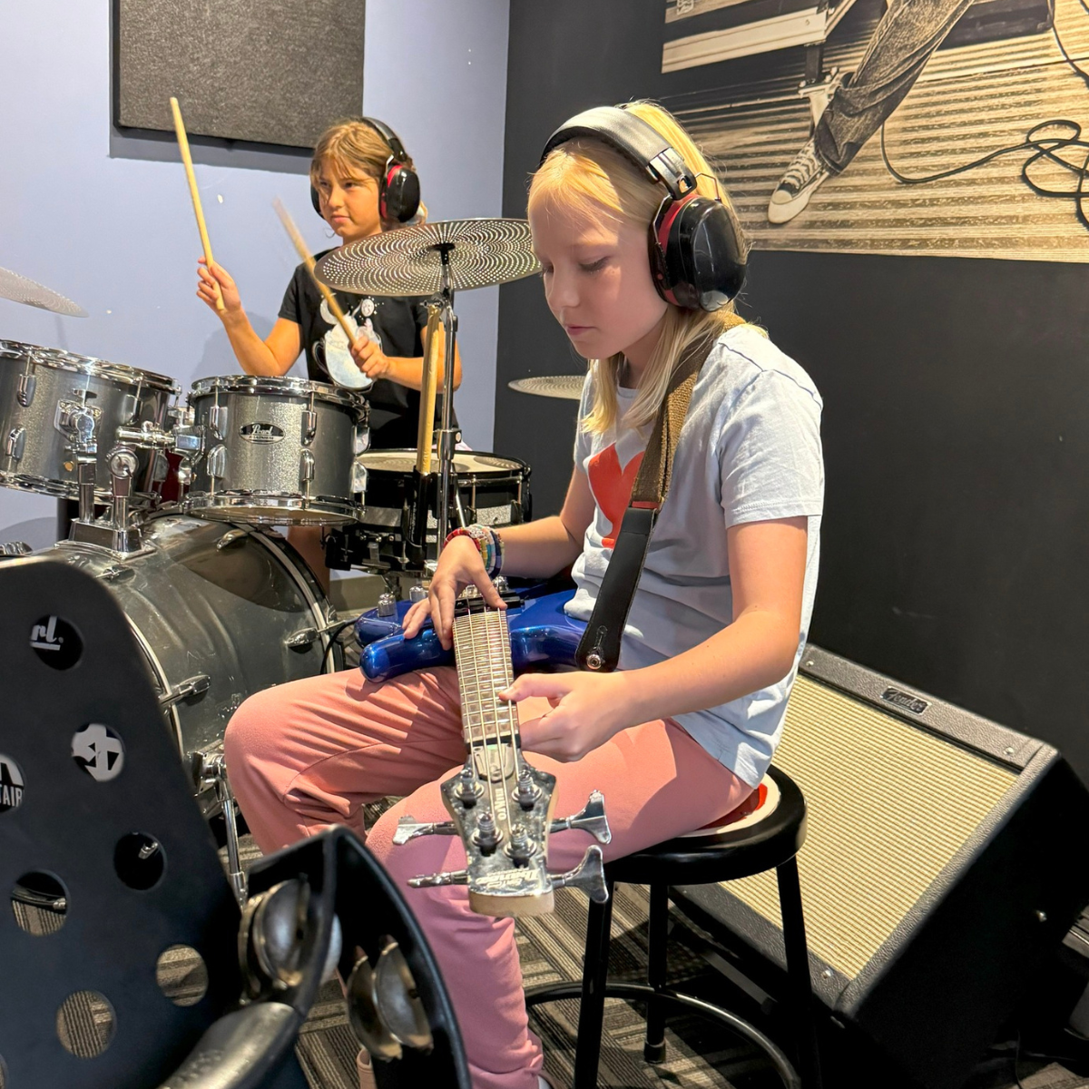 Children playing drums and gutair at School of Rock summer camp 