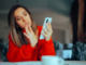 Woman swiping right on her phone while drinking coffee